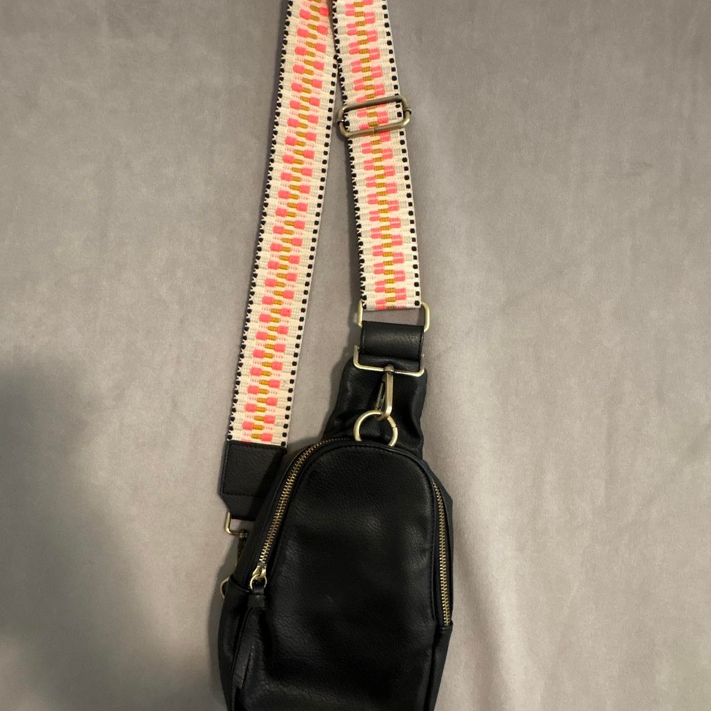 Anthropologie black leather crossbody bag w/ pink and white zigzag pattern strap
